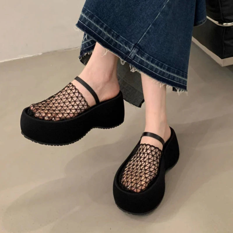 Women’s platform wedge sandals with black mesh upper and thick black sole