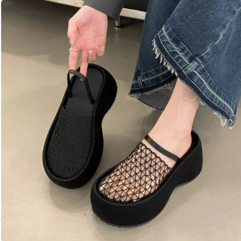 Close-up of women’s platform wedge sandals with black mesh and ankle strap